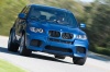 Driving 2013 BMW X5 M in Monte Carlo Blue Metallic from a front right view